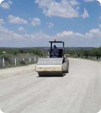 Road roller on newly completed stabilized road